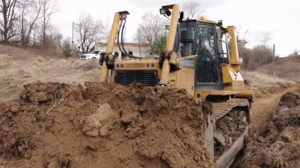 Bulldozer Construction Site Shovels Soil Heap Powerful Yellow Earthmover Crumbles — Stock Video