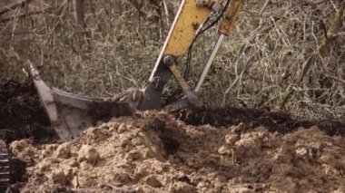 İnşaat malzemeleri. Katlanmış bumbalı ağır sarı kazıcı. İnşaat şirketi için kazıcı ağır makineler. Kazı makinesi. Toprak taşıma ekipmanı. Kazı aracı. Ereksiyon işi.