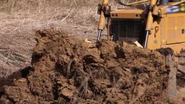 Heavy backhoe construction machinery equipment concept. Earth mover, bulldozer. Yellow front-end loader or all-wheel bulldozer. Heavy machinery machine and manufacturing equipment for open-pit mining.