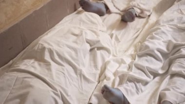 Dead mans foot covered with a sheet. Many victims of coronavirus infected person death around the world, severe epidemic that leads to enormous loss during coronavirus outbreak.