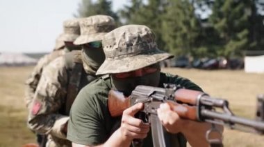 Soldiers with weapons and ammunition attack the enemy on the battlefield. This is a Military Special Forces Unit.