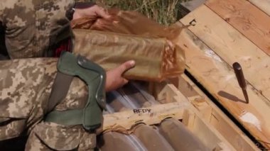 The Chevron of the Ukrainian state coat of arms is displayed on the arm of a serviceman of Ukrainian army as he prepares for firing RPG-7, Precision Shoulder-fired Rocket Launcher, PSRL-1. close up
