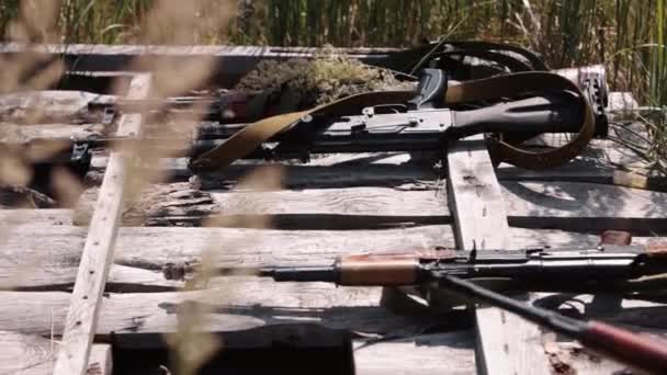 Close Soldiers Hand Placing Kalashnikov Ak47 Machine Gun Wooden Boards — Stock Video