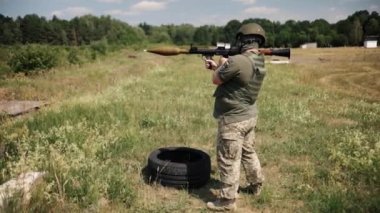 The soldier wears a helmet, military uniform, and body armor while firing a Precision Shoulder-Fired Rocket Launcher RPG-7 PSRL-1 at the enemy.