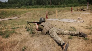 Unloading machine gun, soldier lying with gun, Army war concept, ready to attack, Corps machine gun crew shooting, Army gunner attacking