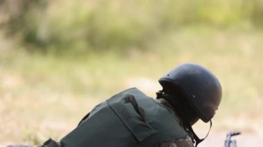 Armed military man unloading machine gun while lying with gun, soldier lying with gun, Military, Army war concept, ready to attack, Corps machine gun crew shooting, Army gunner attacking
