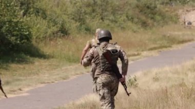 Armed soldiers running forward during military operations
