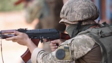 Unloading machine gun, soldier lying with gun, Army war concept, ready to attack, Corps machine gun crew shooting, Army gunner attacking