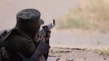 Unloading machine gun, soldier lying with gun, Army war concept, ready to attack, Corps machine gun crew shooting, Army gunner attacking