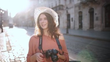 Young pretty woman tourist taking photo of herself in city, Photographer taking photographs, Urban concept, female traveler, cheerful beautiful lady with camera walking outdoors in city. Go Everywhere