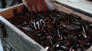 Hand taking ammo. Ammo taken by hand, ammunition for ak47 in 7,62 caliber, gun crime, war bullet weapon, bullet shells, shell gun ammunition, Close up shell gun ammunition.