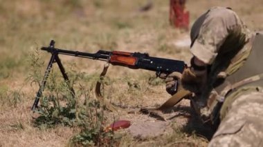 Unloading machine gun, soldier lying with gun, Army war concept, ready to attack, Corps machine gun crew shooting, Army gunner attacking