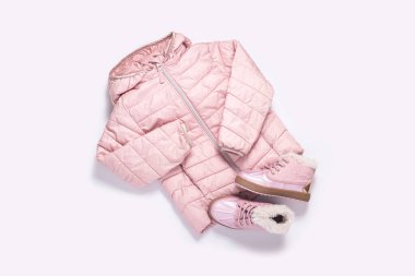 Beyaz arka plandaki bir kız için çocuk ceketi ve botları. Üst manzara, düz yatış. Pankart.