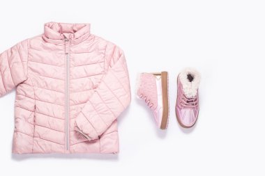Beyaz arka plandaki bir kız için çocuk ceketi ve botları. Üst manzara, düz uzanma