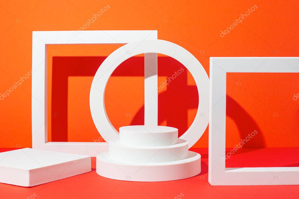 White geometric shapes podiums pedestals for presentation on a red background.