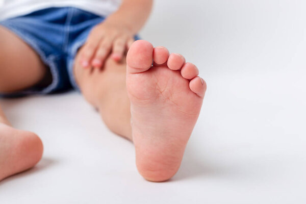 Child bare feet. Studio shot on a light background. 