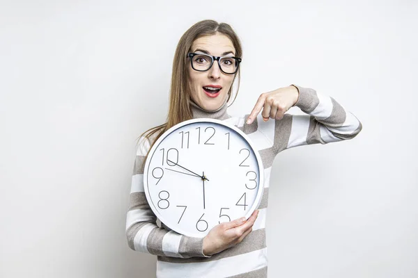 Mujer Joven Sorprendida Señalando Reloj Pared Sobre Fondo Claro — Foto de Stock