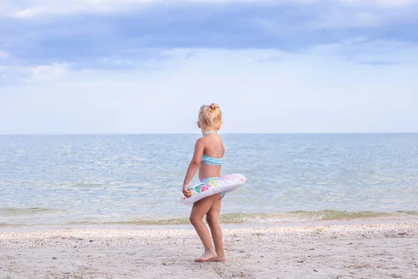 Child Blond Girl Rubber Ring Stands Beach — Foto de Stock