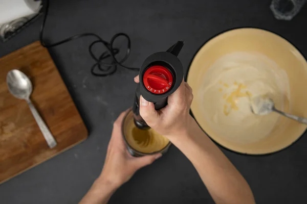 Woman kneading pastry dough with mixer. Top view, flat lay.