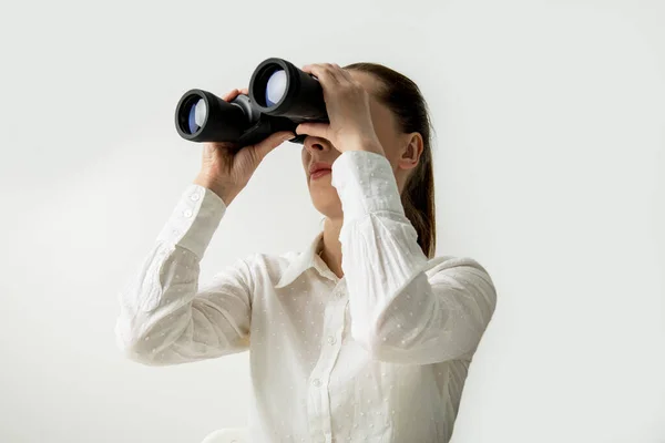 Young Woman White Shirt Looks Binoculars White Background — Stok fotoğraf