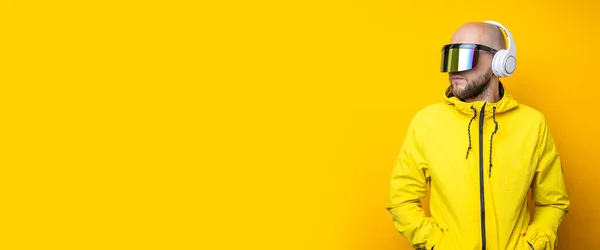 Stylish Young Man Cyberpunk Glasses Yellow Jacket Headphones Yellow Background — Foto de Stock