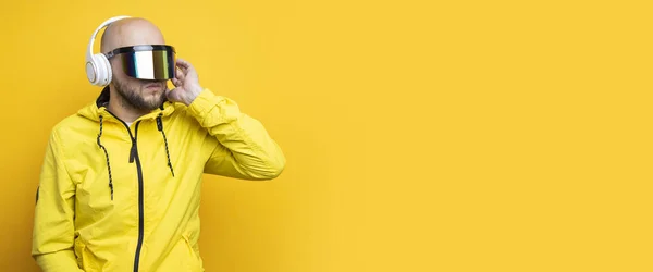 Stylish Young Man Cyberpunk Glasses Yellow Jacket Headphones Yellow Background — Stock Fotó