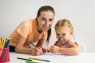 Smiling girl child and mother are painted with colored pencils on paper.