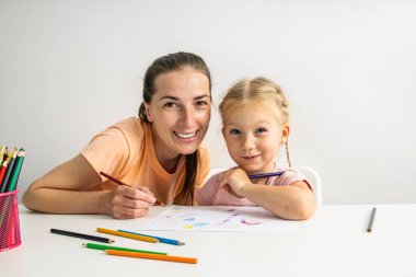 Smiling girl child and mother are painted with colored pencils on paper.