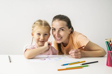 Smiling girl child and mother are painted with colored pencils on paper.