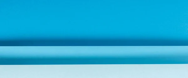 Colorful blue folded paper material design horizontally. Top view, flat lay. Banner.