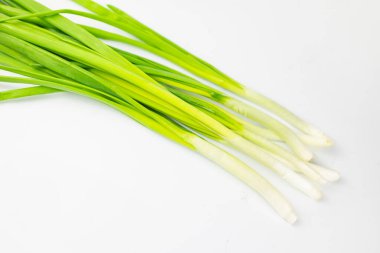 bunch of green onions on white background