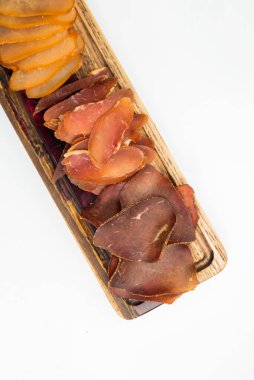 appetizer assorted cut meat smoked dried jamon basturma on a wooden board on a white background
