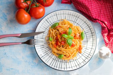 Italian pasta in a restaurant with tomato sauce and basil