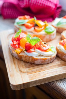 crispy bruschetta bread with mozzarella cheese with tomatoes and basil