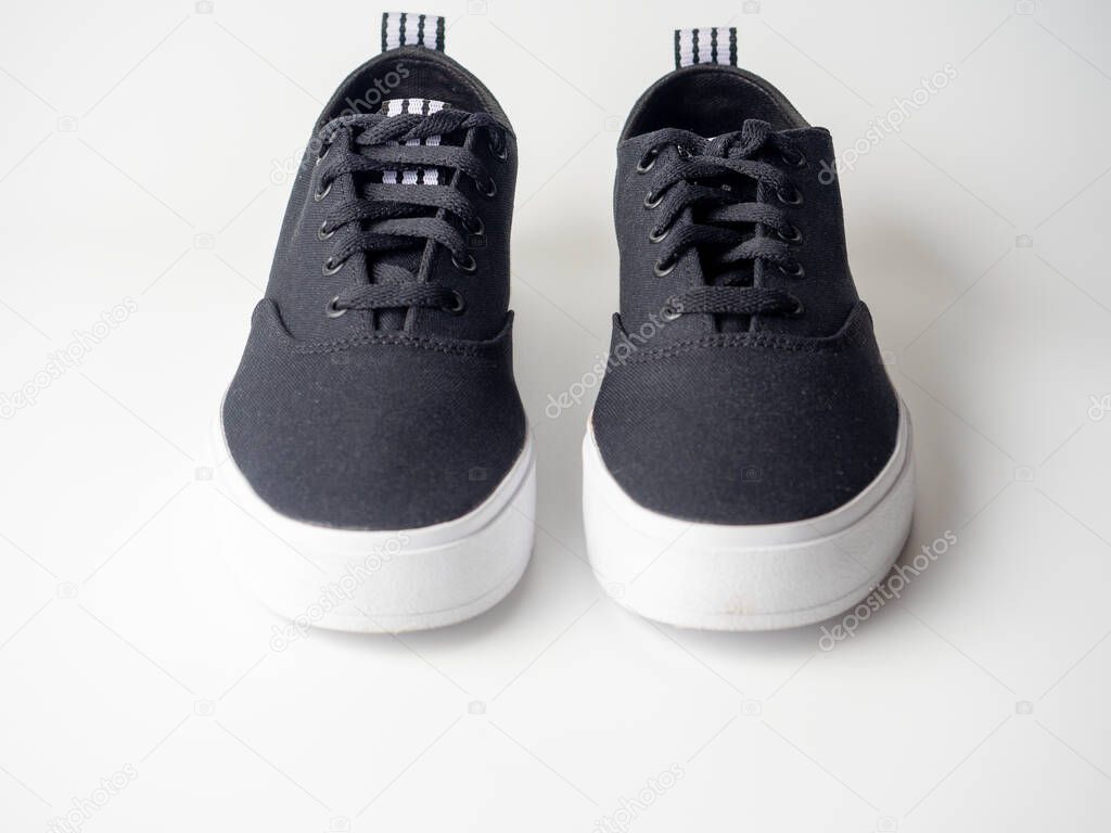 01.05.2021 Russia, Moscow. Close-up of black Adidas canvas sneakers isolated on a white background. Product shot, side view