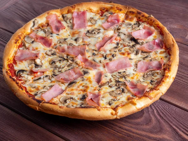 Zbliżenie Pizza Szynką Grzybami Brązowym Drewnianym Tle Tradycyjne Włoskie Danie — Zdjęcie stockowe