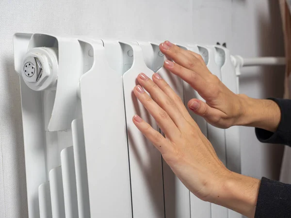 Woman Warms Her Hands Central Heating Battery High Payments Heating Royalty Free Stock Images