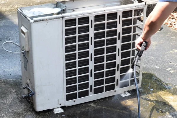 air condition cleaning concept. Worker cleaning air conditioner dirty machine. Air condition Cleanning with Professional Cleanner service and maintenance, fixing and cleaning the filters.