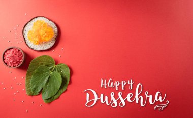 Mutlu Dussehra. Sarı çiçekler, yeşil yaprak ve kırmızı arka planda pirinç. Dussehra Hint Festivali konsepti.
