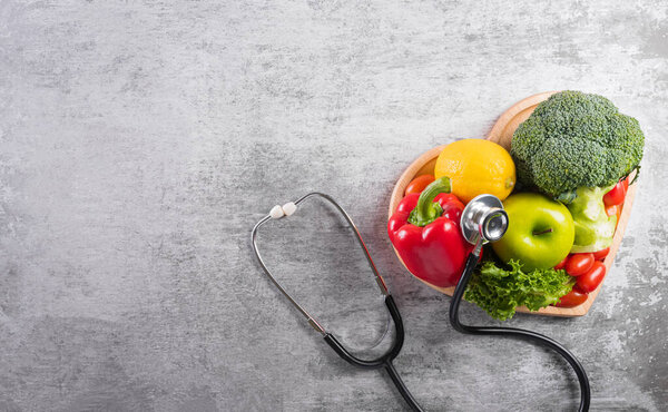 World diabetes day and healthcare concept. Healthy food eating nutrition in plate and stethoscope on stone background.