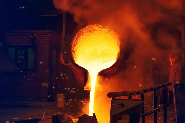 Виробництво ливарного чавуну. Розплавлений метал, що ллється з соусу у форму — стокове фото