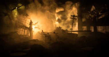 Savaş Konsepti. Askeri siluetler savaş sisli gökyüzü arka planında savaş sahnesi, Dünya Savaşı Askerleri Silueti Bulutlu Gökyüzünün Altında Gece. Harap olmuş şehirde savaş. Seçici odak