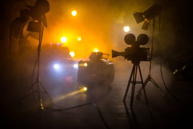 Aksiyon filmi konsepti. Polis arabaları ve minyatür filmler sisli, koyu tonlu arka planda. Polis arabası gece bir arabayı kovalıyor. Suç mahalli kazası. Seçici odak