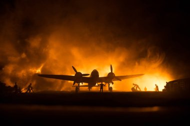 German Junker (Ju-88) night bomber at night. Artwork decoration with scale model of jet-propelled plane in possession. Toned foggy background with light. War scene. Selective focus clipart