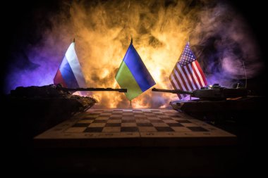 War between Russia and Ukraine, conceptual image of war using chess board and national flags on the background of explosion. Ukrainian and Russian crisis, political conflict. Selective focus