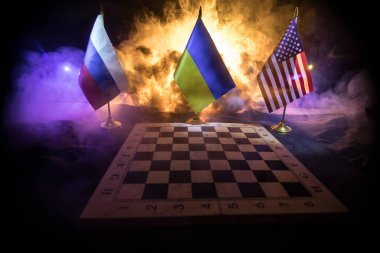 War between Russia and Ukraine, conceptual image of war using chess board, soldiers and national flags on the background of explosion. Ukrainian and Russian crisis. Selective focus