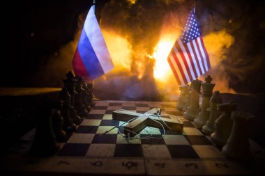 Concept of war or manipulation with global politics. War between Russia and Ukraine, conceptual image of war using chess board and national flags on the background of explosion.