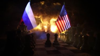 Concept of war or manipulation with global politics. War between Russia and Ukraine, conceptual image of war using chess board and national flags on the background of explosion.