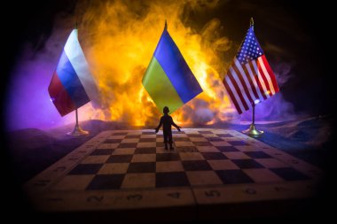 War between Russia and Ukraine, conceptual image of war using chess board, soldiers and national flags on the background of explosion. Ukrainian and Russian crisis. Selective focus