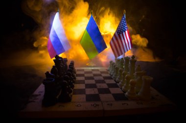 War between Russia and Ukraine, conceptual image of war using chess board, soldiers and national flags on the background of explosion. Ukrainian and Russian crisis. Selective focus